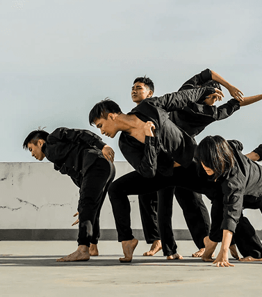 Group dance in dark clothing